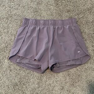 These are purple athletic shorts with biker shorts on the inside.
